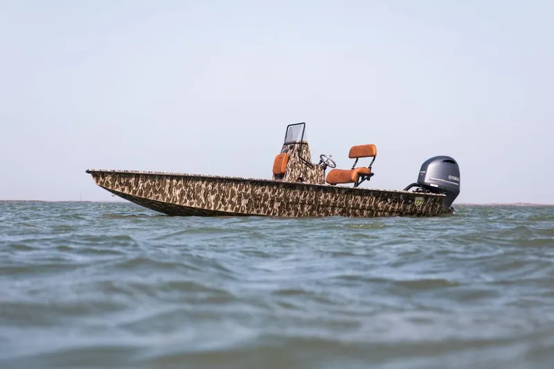 Slide: The Image of Avid 21 Fusion 2026 boat with camouflage design on open water. - 6