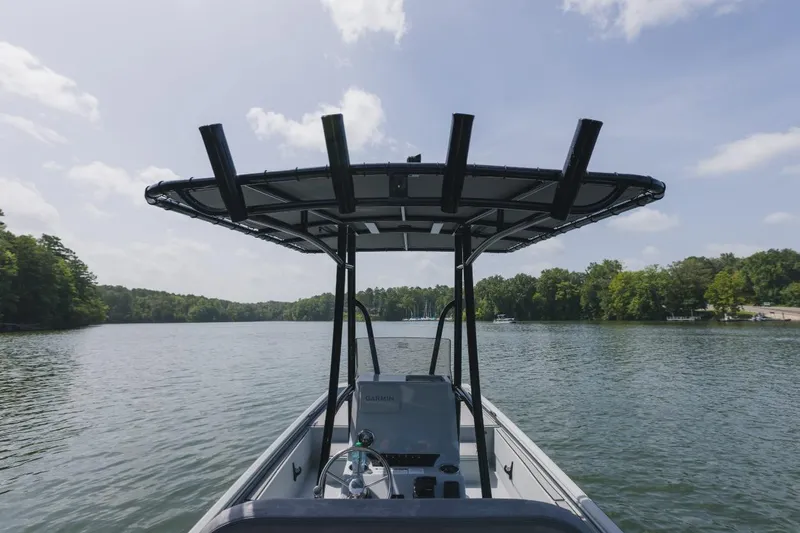 Slide: The Image of 2026 Avid 20 Rogue CC boat deck with wood finish and storage compartments. - 19