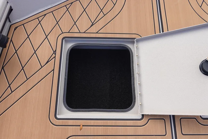 Slide: The Image of Open storage compartment on 2026 Avid 20 Rogue CC boat deck. - 26