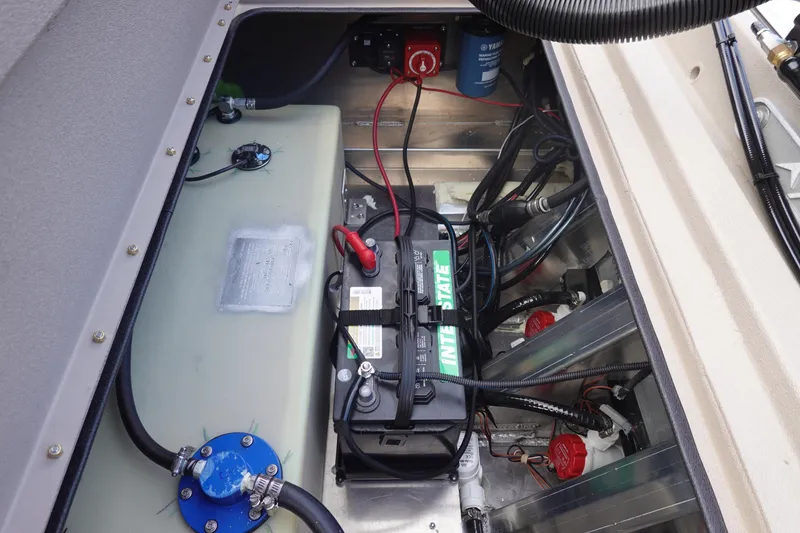 Slide: The Image of Battery compartment of 2026 Avid 20 Rogue CC boat, featuring wiring and components. - 29