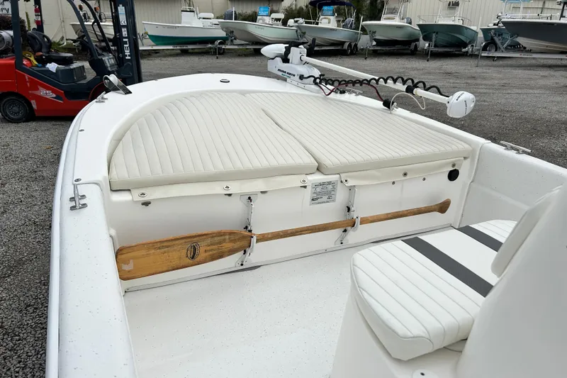 Slide: The Image of 2011 Carolina Skiff JVX18CC boat interior with white seating and wooden paddle. - 14