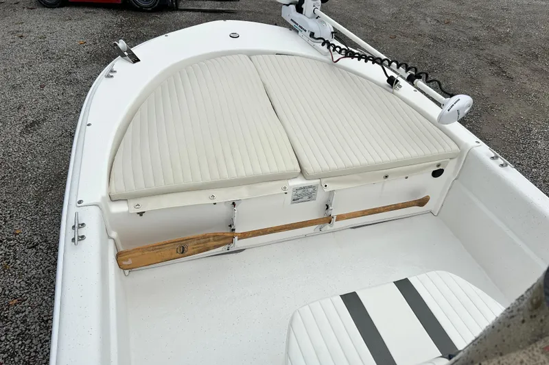 Slide: The Image of 2011 Carolina Skiff JVX18CC boat interior with cushioned seating and trolling motor. - 16