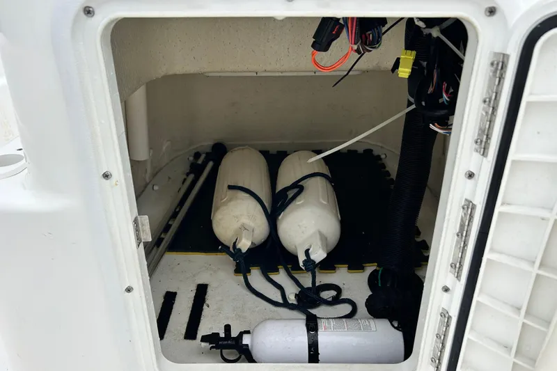 Slide: The Image of Storage compartment of a 2011 Carolina Skiff JVX18CC with fenders and equipment. - 20