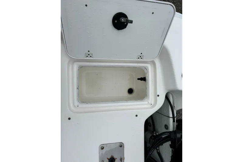 Slide: The Image of Open storage compartment on 2011 Carolina Skiff JVX18CC boat. - 21