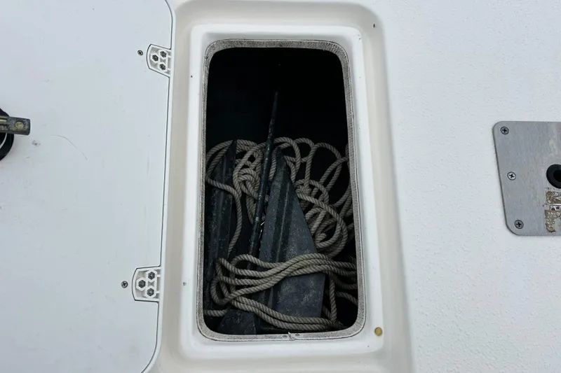 Slide: The Image of Open storage compartment with ropes and anchor on a 2011 Carolina Skiff JVX18CC boat. - 26
