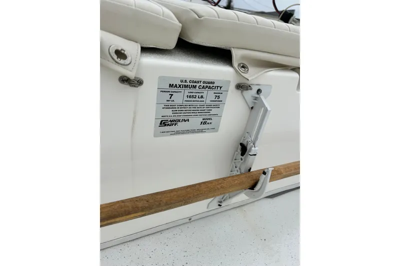Slide: The Image of 2011 Carolina Skiff JVX18CC boat capacity label, showing maximum load and passenger limits. - 31