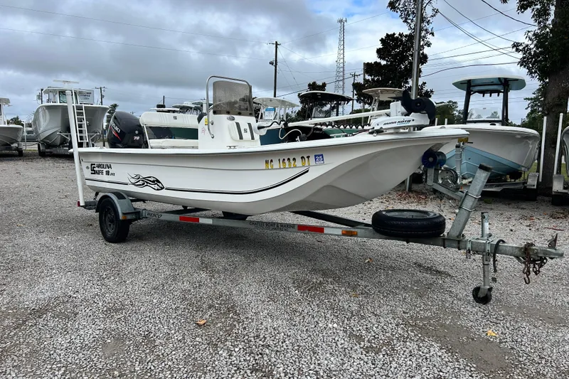 Slide: The Image of 2011 Carolina Skiff JVX18CC boat on trailer in a gravel lot. - 6