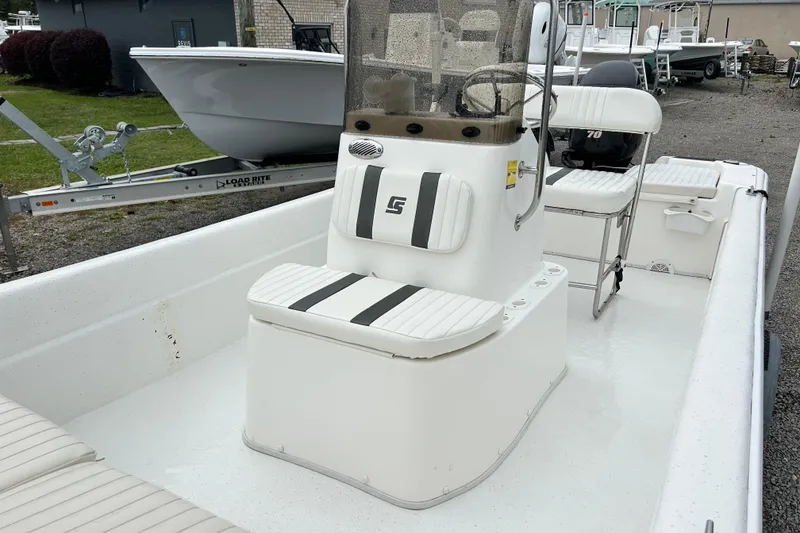 Slide: The Image of 2011 Carolina Skiff JVX18CC boat interior with white seating and console. - 9