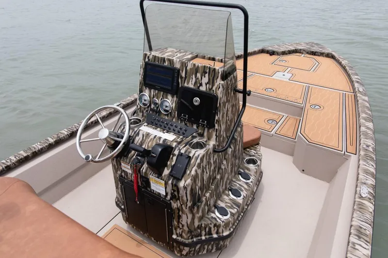 Slide: The Image of 2026 Avid 21 FST boat interior with camouflage console and modern steering wheel. - 10