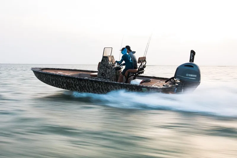 Slide: The Image of Avid 21 FST 2026 boat speeding on water with Yamaha engine, two passengers onboard. - 5