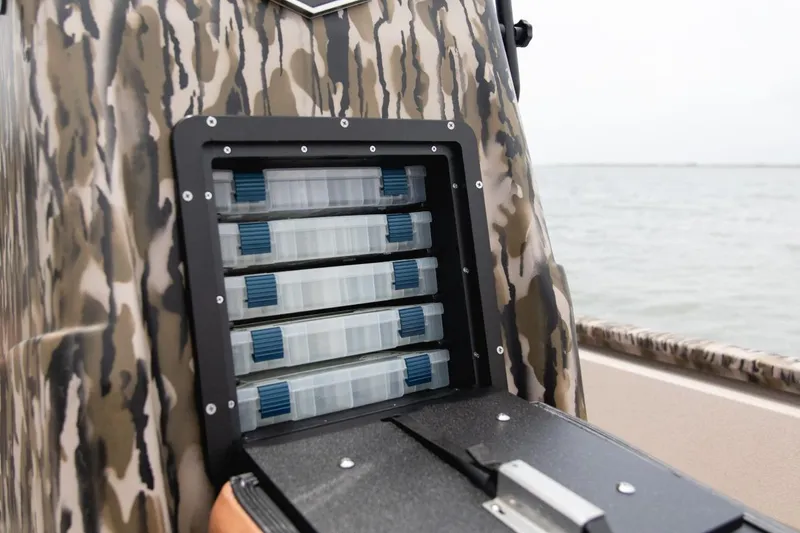 Slide: The Image of Camouflage-patterned Avid 21 FST boat storage compartment with tackle boxes, 2026 model. - 9
