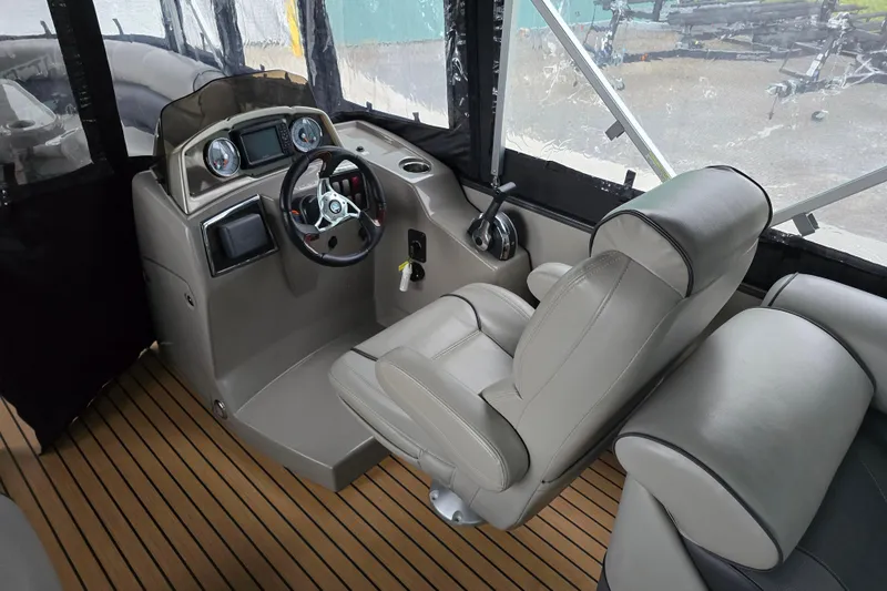 Slide: The Image of 2015 Premier 230 SunSation RF boat interior with steering console and comfortable seating. - 22