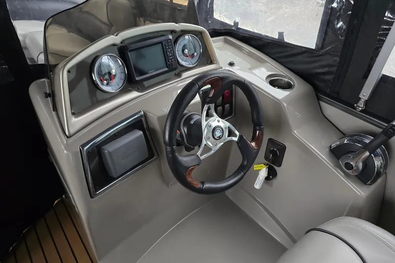Slide: The Image of 2015 Premier 230 SunSation RF boat dashboard with steering wheel and gauges. - 24