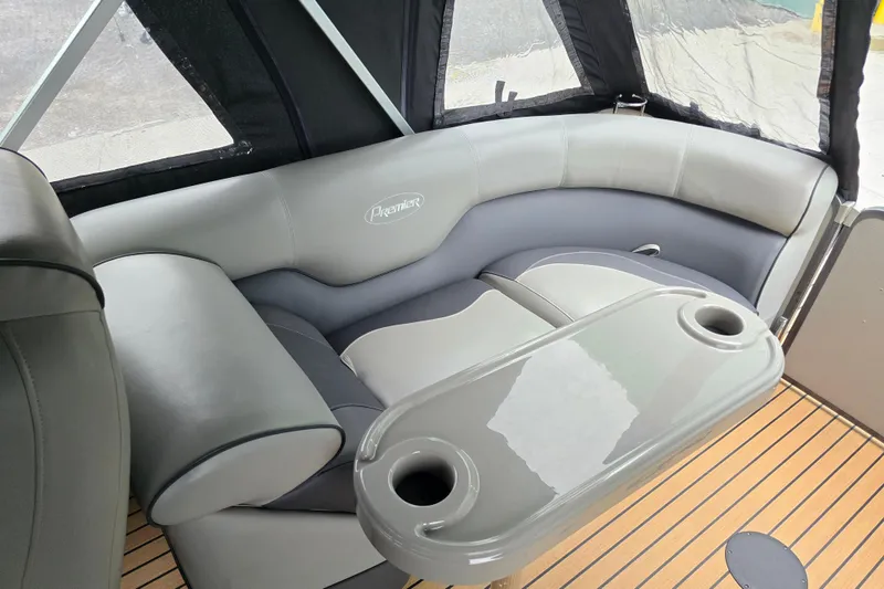 Slide: The Image of 2015 Premier 230 SunSation RF boat interior with cushioned seating and cup holders. - 29