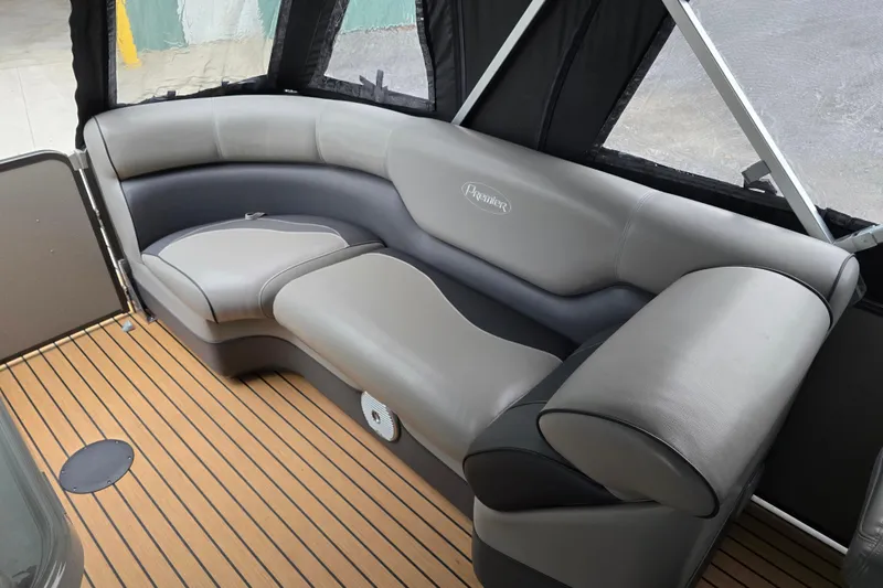 Slide: The Image of 2015 Premier 230 SunSation RF boat interior with gray seating and wood-style flooring. - 30