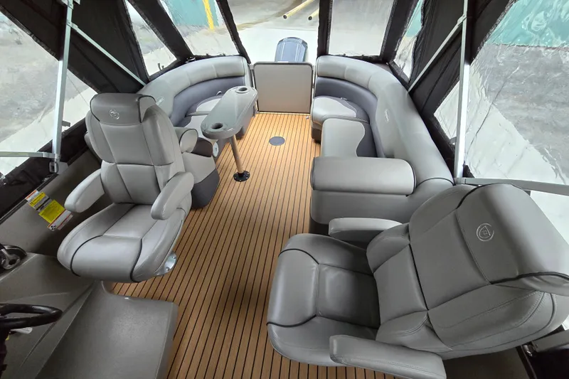 Slide: The Image of 2015 Premier 230 SunSation RF boat interior with gray seating and wood-style flooring. - 32