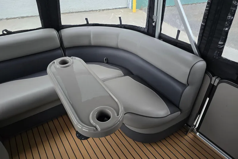 Slide: The Image of 2015 Premier 230 SunSation RF interior with gray seating and table, wooden floor. - 38