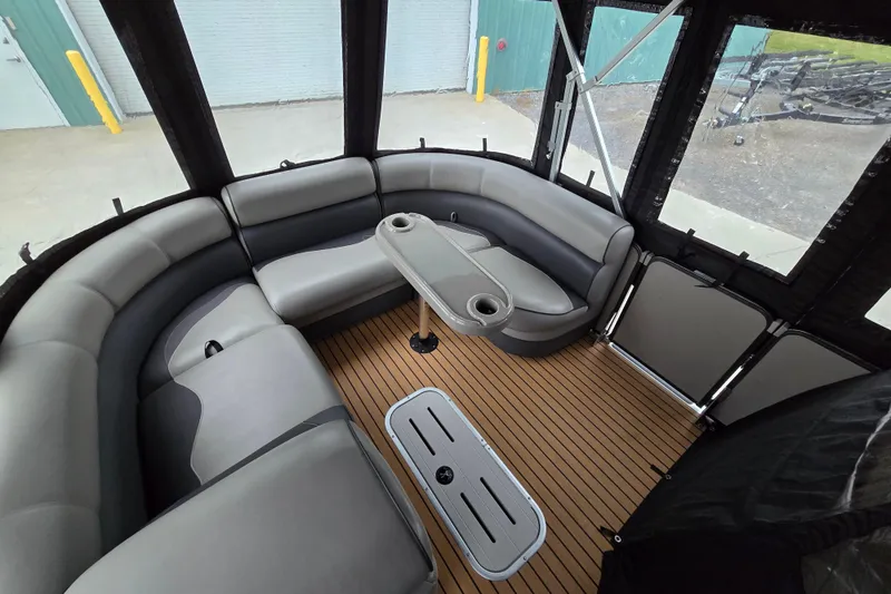 Slide: The Image of 2015 Premier 230 SunSation RF boat interior with cushioned seating and wood-style flooring. - 39