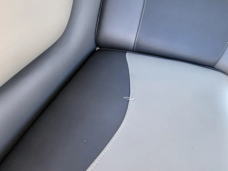Slide: The Image of 2015 Premier 230 SunSation RF boat seat with visible stitching and slight wear. - 42