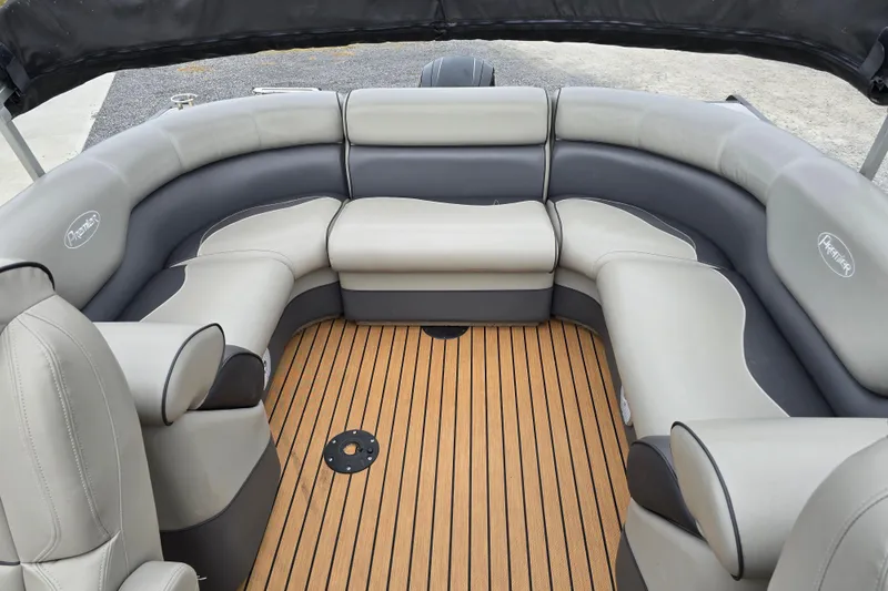 Slide: The Image of 2015 Premier 230 SunSation RF boat interior with plush seating and wood-style flooring. - 44