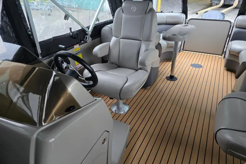 Slide: The Image of 2015 Premier 230 SunSation RF boat interior with luxurious seating and wood-style flooring. - 49