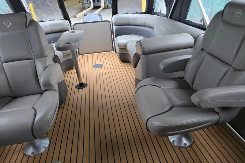 Slide: The Image of Interior of 2015 Premier 230 SunSation RF boat with luxurious seating and wood flooring. - 50