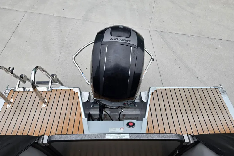 Slide: The Image of 2015 Premier 230 SunSation RF boat with Mercury outboard motor and wooden deck. - 51