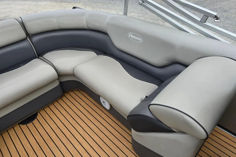 Slide: The Image of 2015 Premier 230 SunSation RF pontoon boat with black canopy, parked near a teal building. - 8