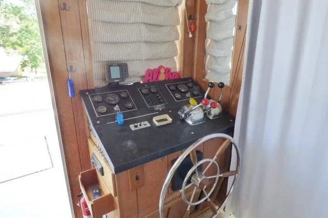 Slide: The Image of 1988 Sumerset 14x65 houseboat helm with vintage controls and steering wheel. - 2