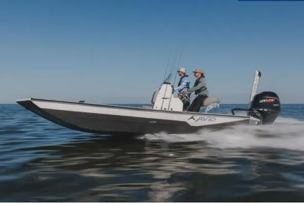 The Image of 2026 Avid 21 Recon boat speeding on open water under clear blue sky. - 1