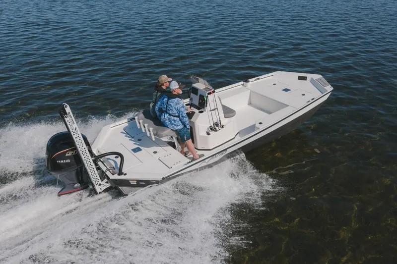 Slide: The Image of Avid 21 Recon 2026 boat cruising on open water with two passengers. - 14