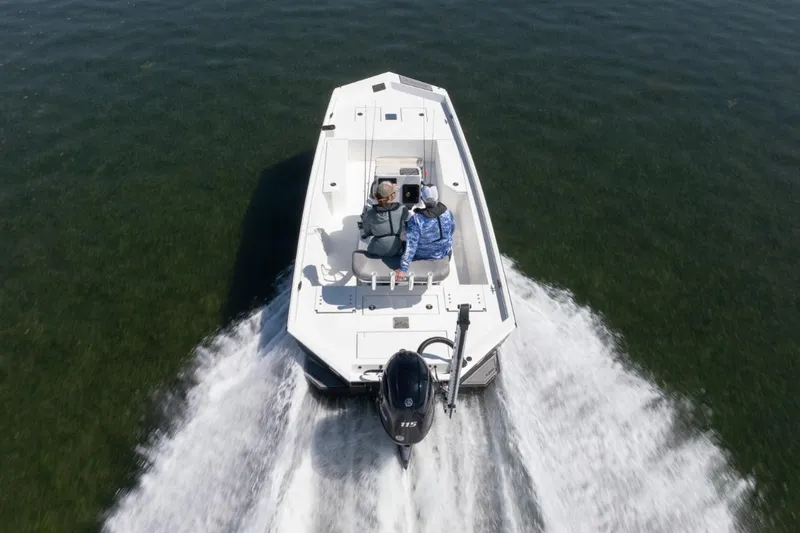 Slide: The Image of Avid 21 Recon 2026 boat cruising on open water, rear view. - 15
