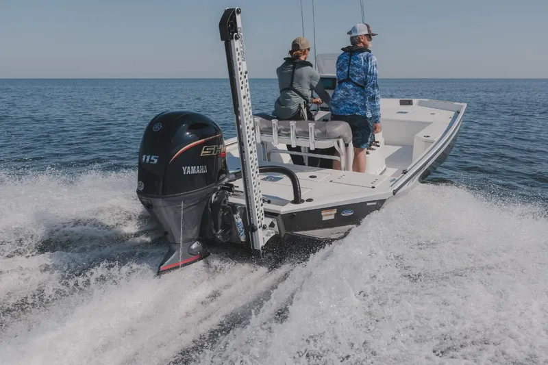 Slide: The Image of Avid 21 Recon 2026 boat cruising on open water with Yamaha engine. - 16