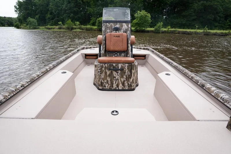 Slide: The Image of Avid 21 Recon 2026 boat on a calm lake with lush green trees. - 8