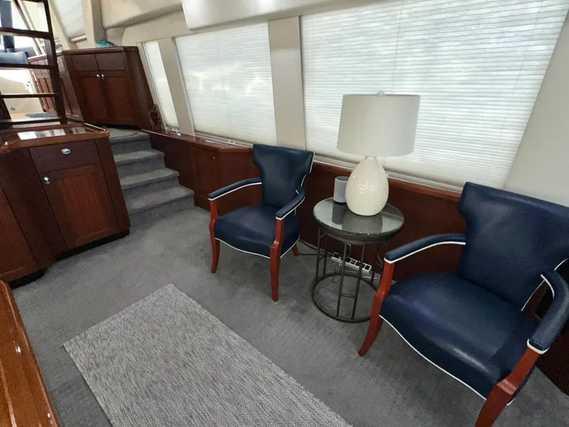 Slide: The Image of Interior of 2003 Pacific Mariner 65 SE Motoryacht with blue chairs and a lamp. - 10