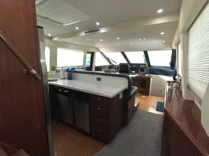 Slide: The Image of Interior of 2003 Pacific Mariner 65 SE Motoryacht with modern kitchen and helm. - 12