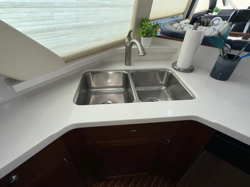 Slide: The Image of Kitchen sink area in 2003 Pacific Mariner 65 SE Motoryacht with dual basins and modern faucet. - 15