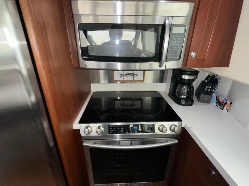 Slide: The Image of Galley kitchen in 2003 Pacific Mariner 65 SE Motoryacht with modern appliances. - 16