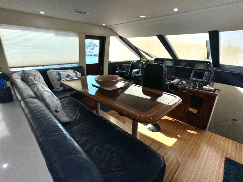 Slide: The Image of Luxurious interior of 2003 Pacific Mariner 65 SE Motoryacht with leather seating and wooden table. - 18