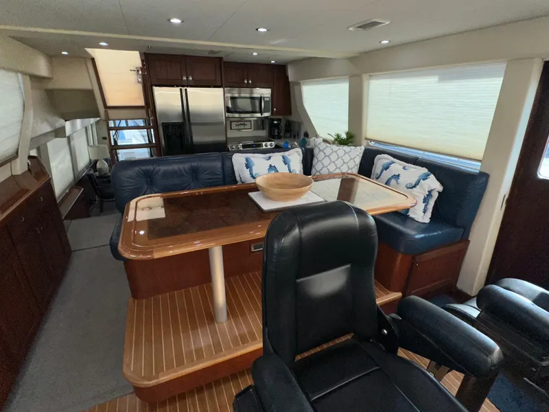 Slide: The Image of Luxurious interior of 2003 Pacific Mariner 65 SE Motoryacht with dining area and modern kitchen. - 21