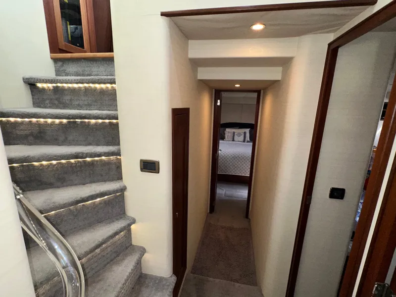 Slide: The Image of Hallway and stairs inside a 2003 Pacific Mariner 65 SE Motoryacht, featuring modern lighting. - 27