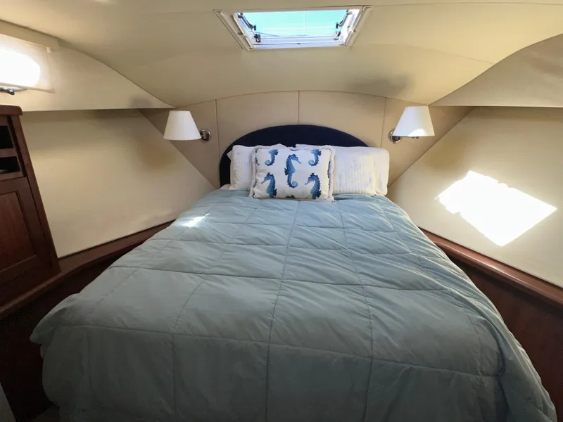Slide: The Image of Cozy bedroom in 2003 Pacific Mariner 65 SE Motoryacht with skylight and seahorse pillows. - 30