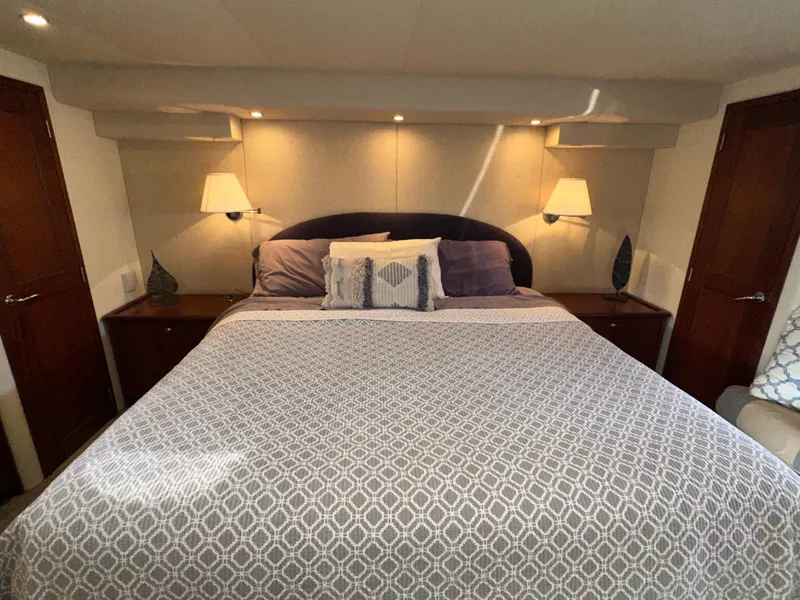 Slide: The Image of Luxurious bedroom interior of 2003 Pacific Mariner 65 SE Motoryacht with elegant bedding and lighting. - 34