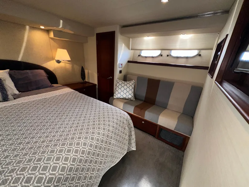 Slide: The Image of Luxurious bedroom interior of 2003 Pacific Mariner 65 SE Motoryacht with bed and seating area. - 36