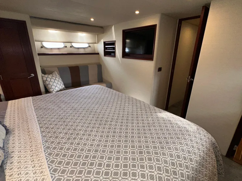 Slide: The Image of Luxurious bedroom in 2003 Pacific Mariner 65 SE Motoryacht with modern decor and cozy bedding. - 38
