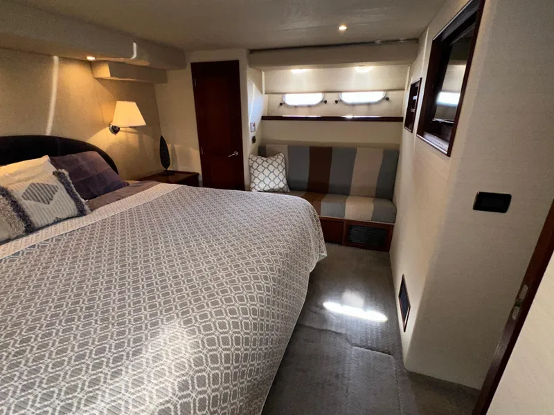 Slide: The Image of Luxurious bedroom in 2003 Pacific Mariner 65 SE Motoryacht with cozy bed and seating area. - 40