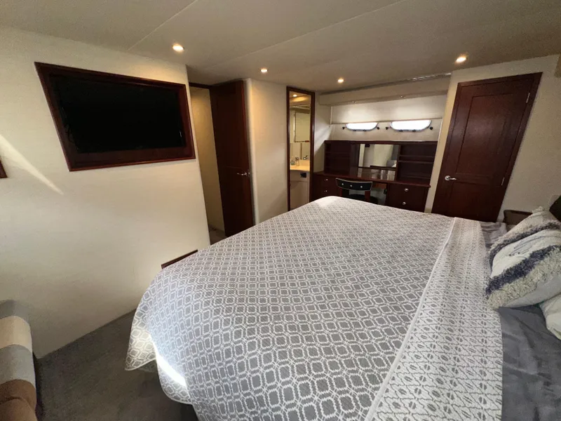Slide: The Image of Luxurious bedroom interior of 2003 Pacific Mariner 65 SE Motoryacht with elegant bedding and wood accents. - 42