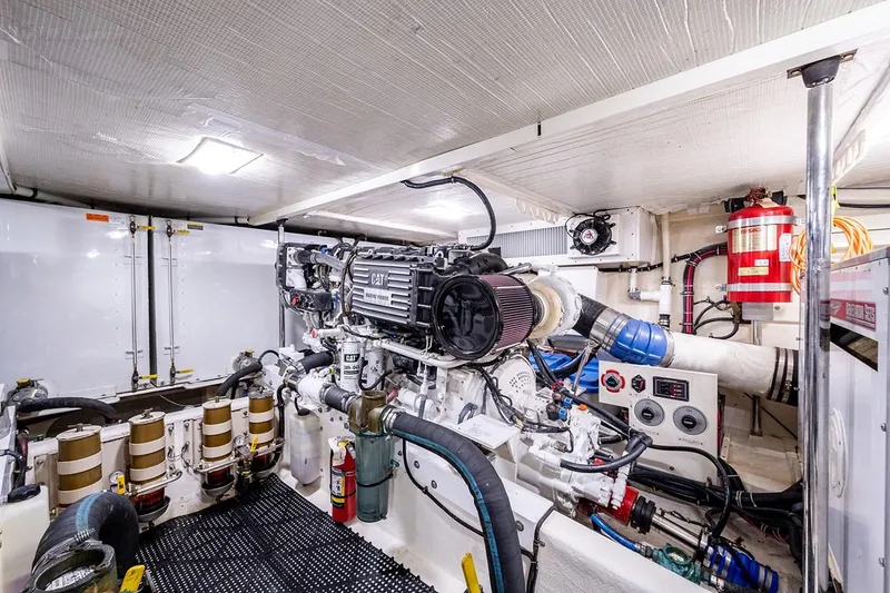 Slide: The Image of Engine room of 2003 Pacific Mariner 65 SE Motoryacht, featuring mechanical components and safety equipment. - 43