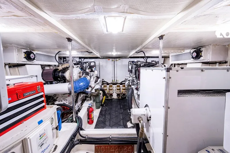 Slide: The Image of Engine room of a 2003 Pacific Mariner 65 SE Motoryacht, featuring dual engines and equipment. - 44