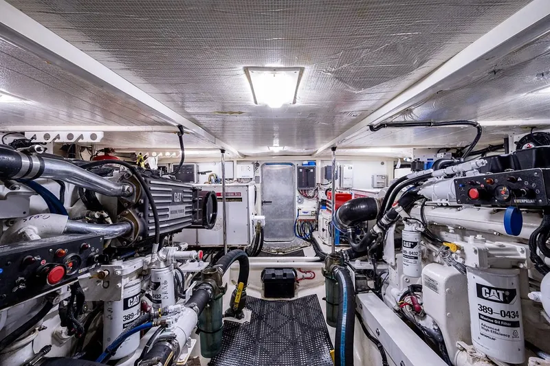 Slide: The Image of Engine room of 2003 Pacific Mariner 65 SE Motoryacht, featuring CAT machinery and complex piping. - 46